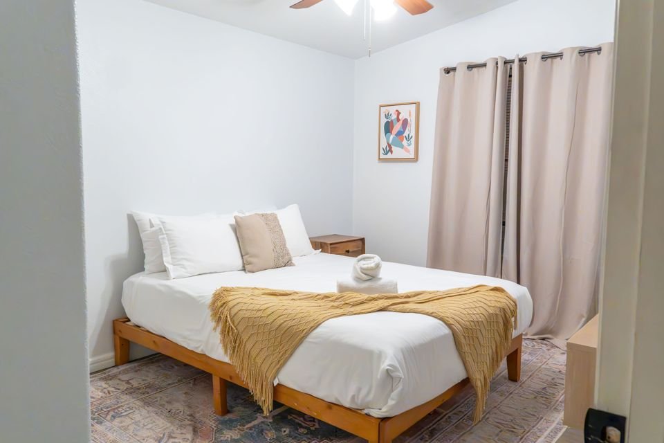 Bedroom with queen bed and warm throw