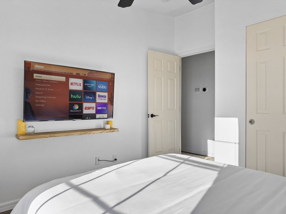 Bedroom with TV and floating shelf
