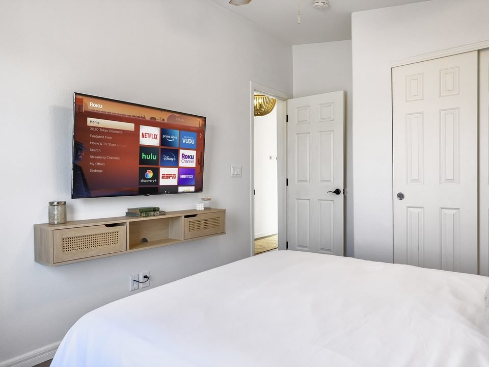 Bedroom with TV and rattan media console