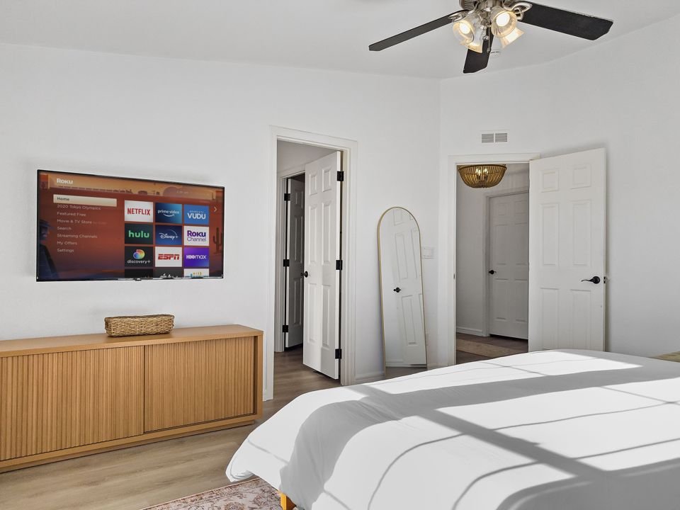 Bedroom with wall-mounted TV