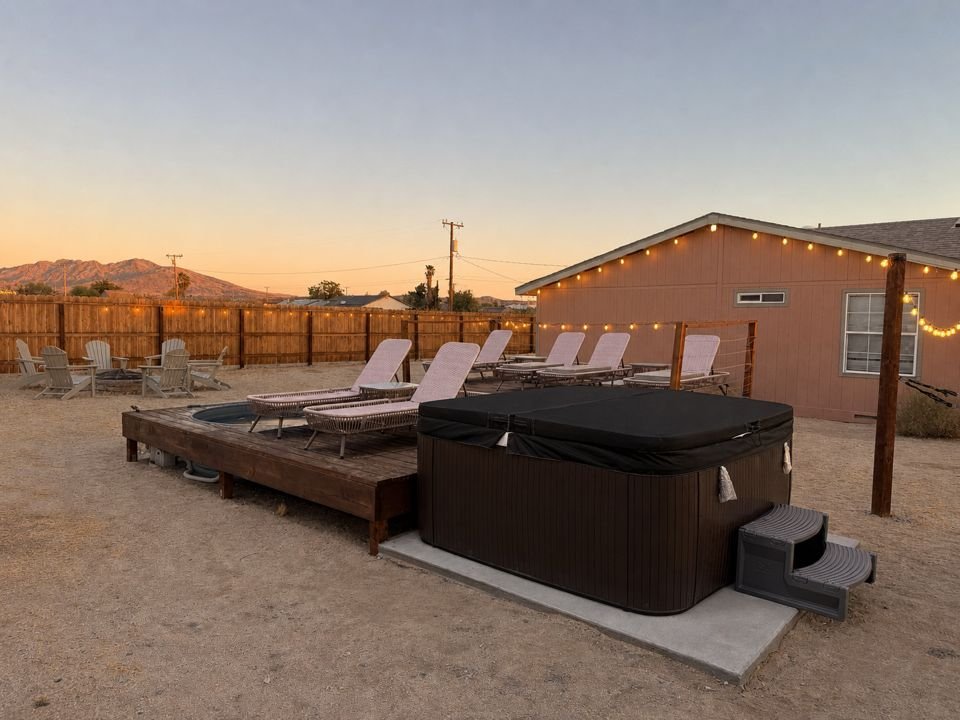 Private hot tub, cowboy soaking pool deck and loungers at sunset