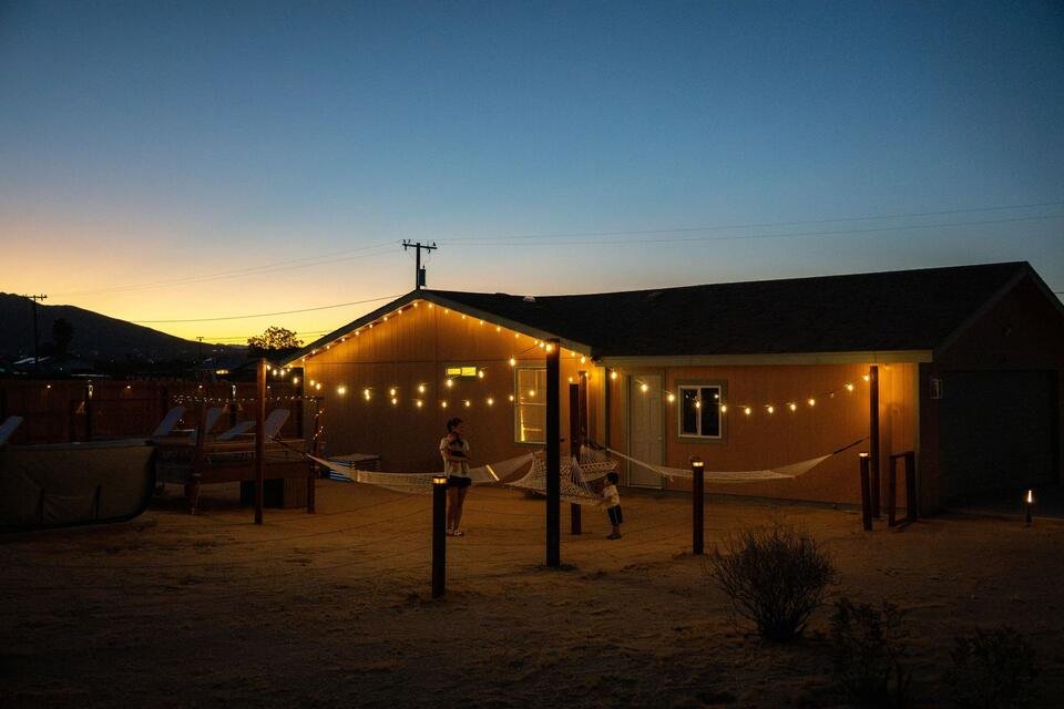 The Leaning Joshua yard at dusk under string lights