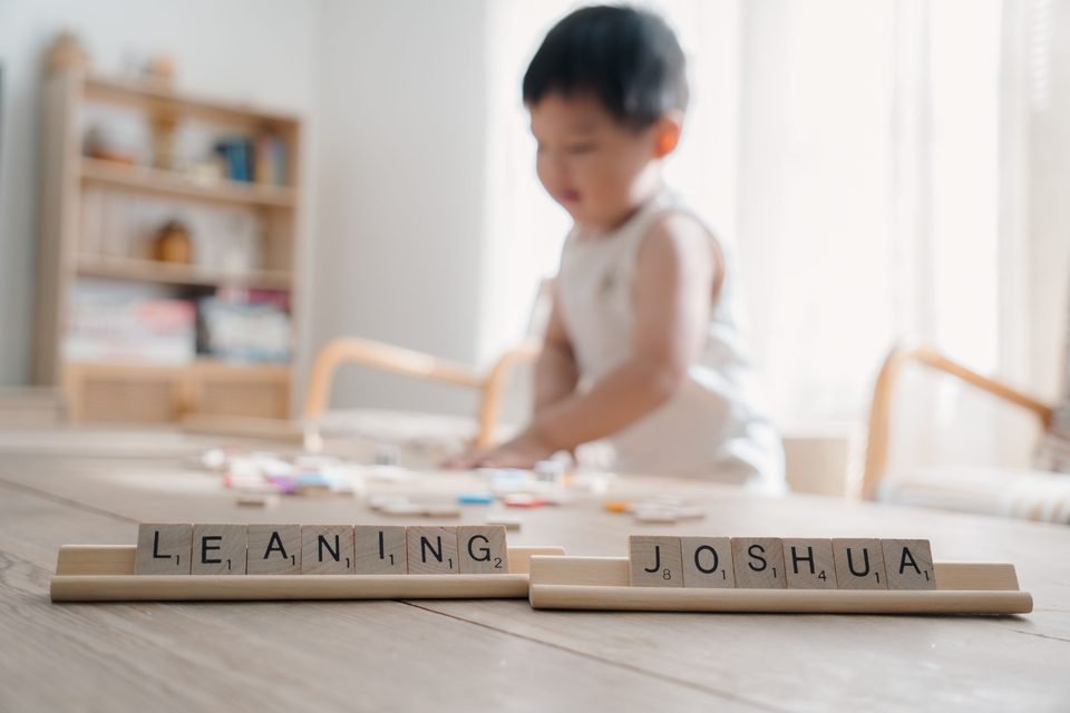 Scrabble tiles spelling Leaning Joshua on the coffee table