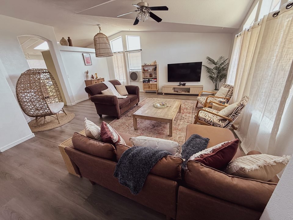 Living room with sectional, rattan egg chair and ceiling fan