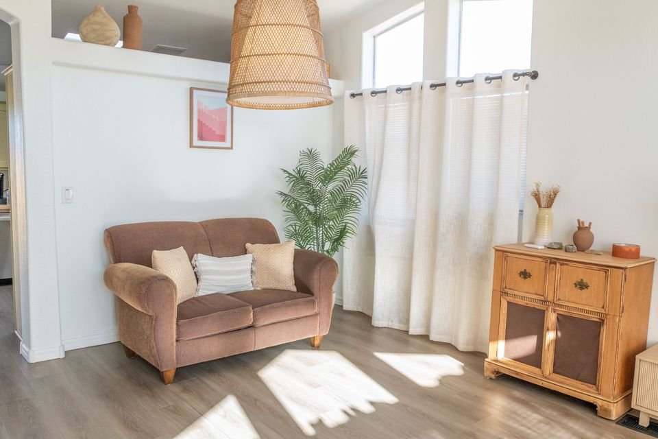 Living room loveseat, curtains and woven pendant light