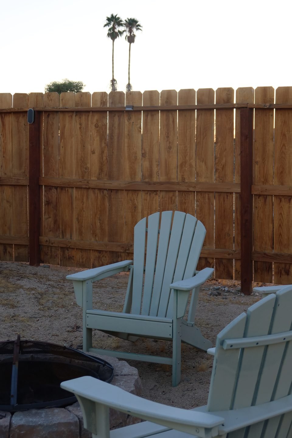 Adirondack chairs beside the fire pit