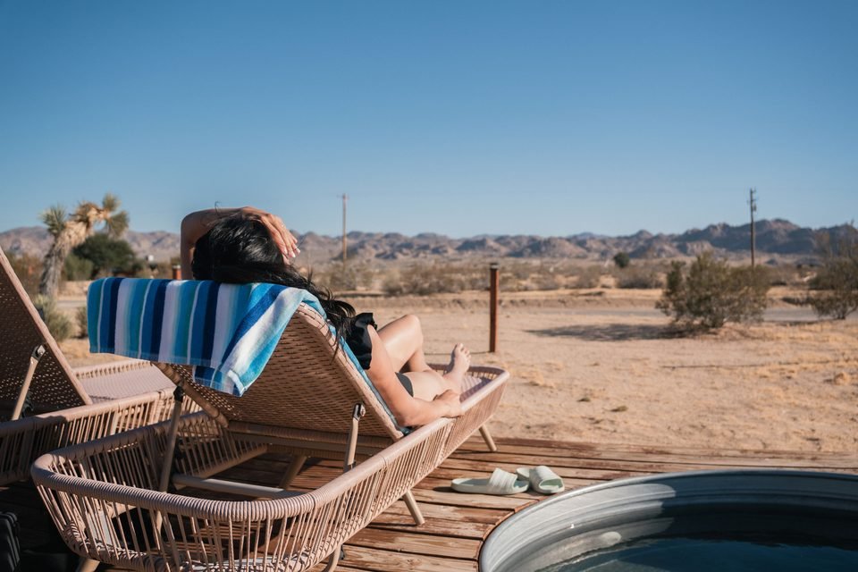 Relaxing on a lounger beside the cowboy soaking pool