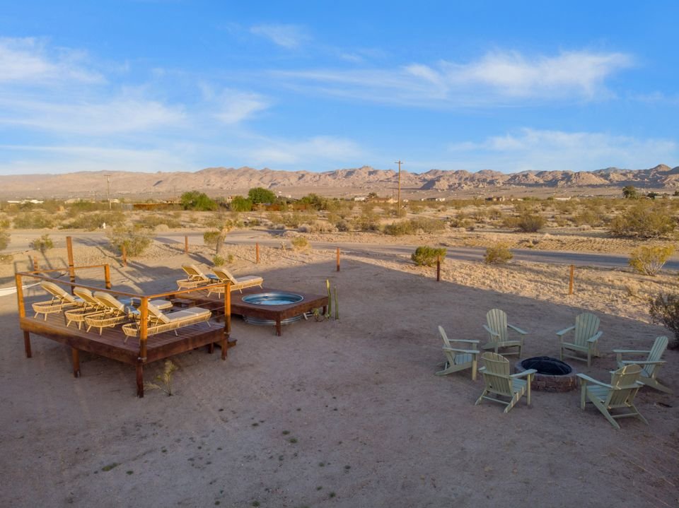 Wide view of the fenced backyard
